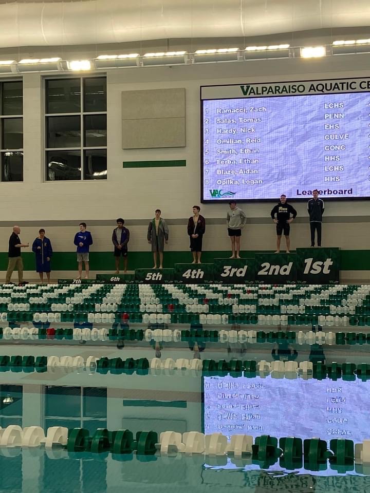 Aidan Blaze on the podium after qualifying for diving at state.