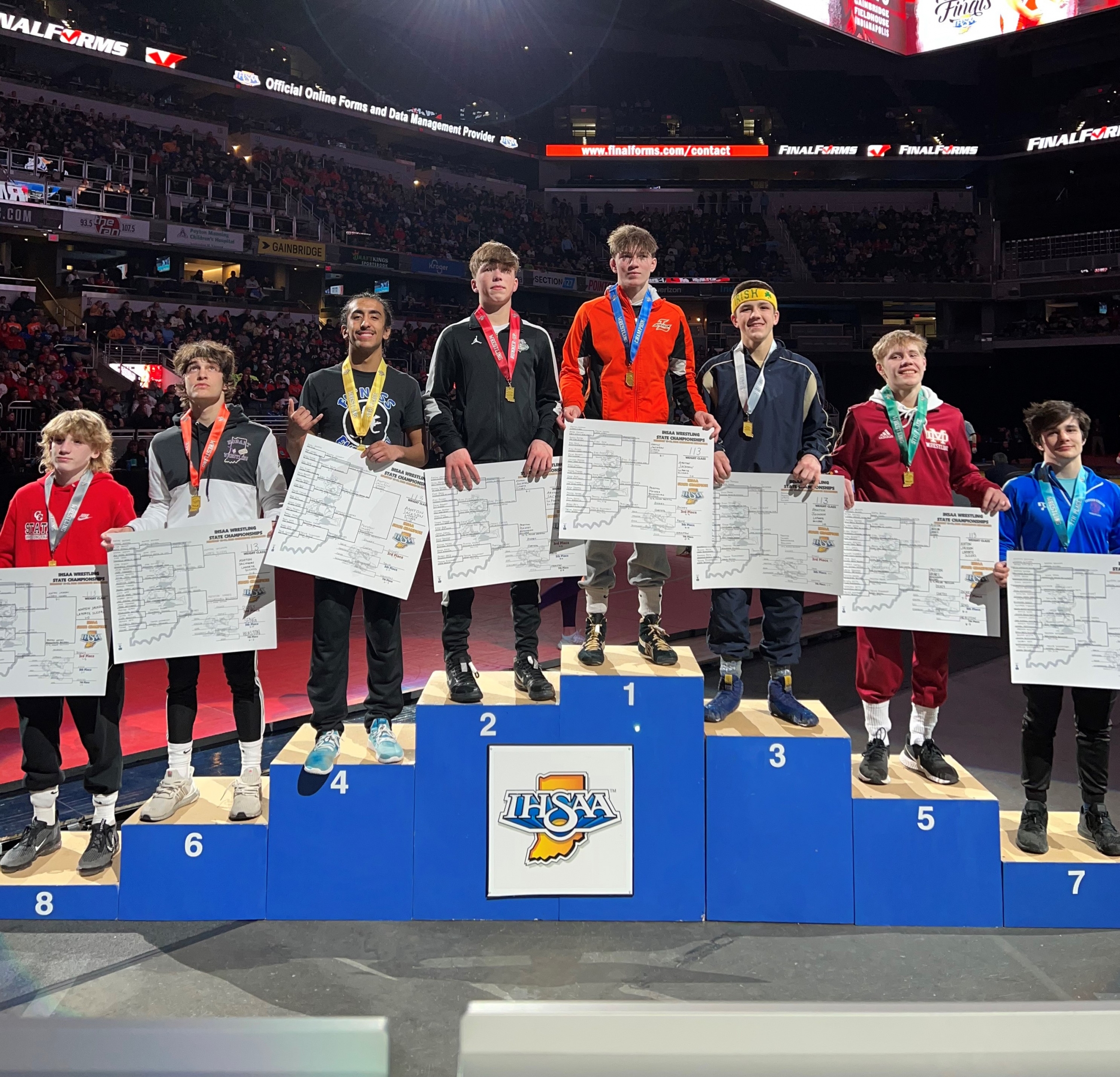 Senior Johnny Cortez stands on the podium receiving his medal for his 4th place finish at state.